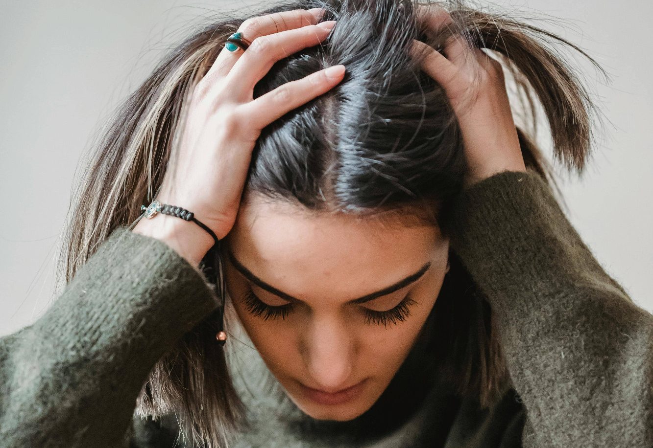 stress une jeune femme la tête dans les mains stressée